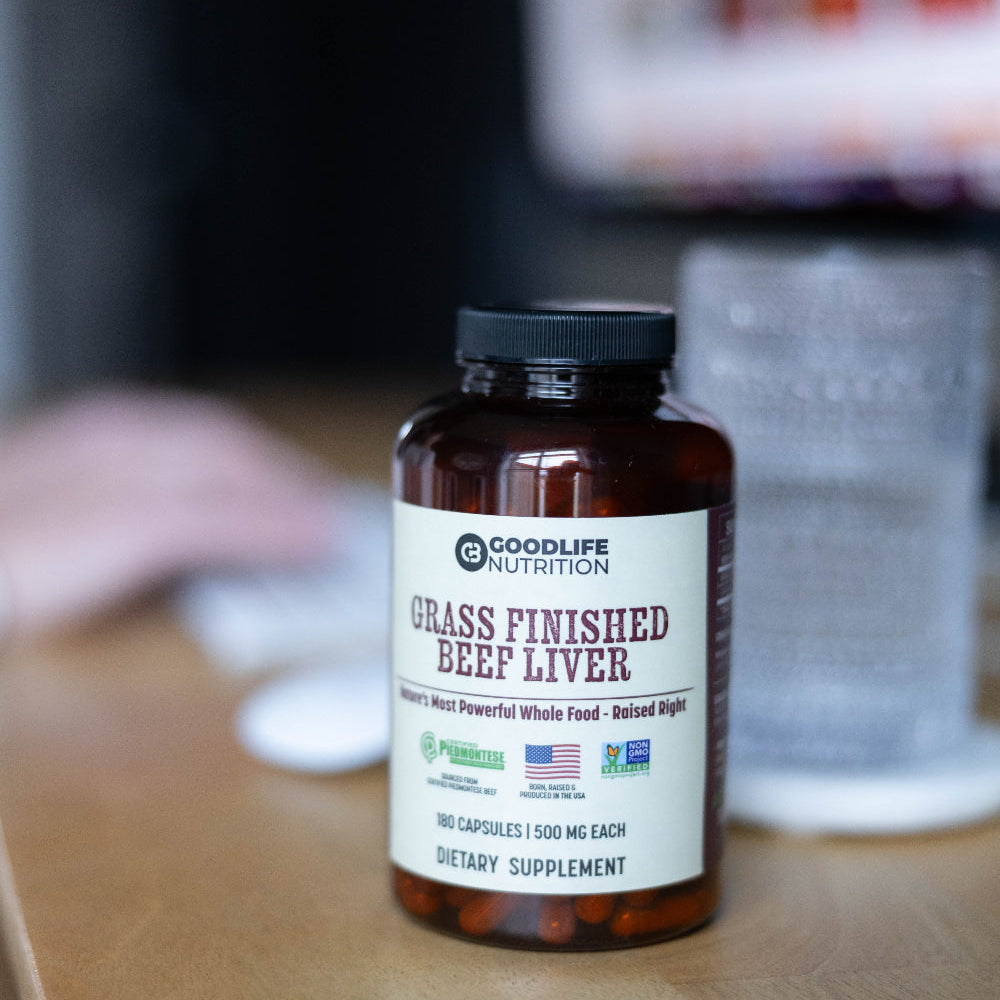 Goodlife Nutrition grass finished beef liver supplement bottle on a wooden surface.
